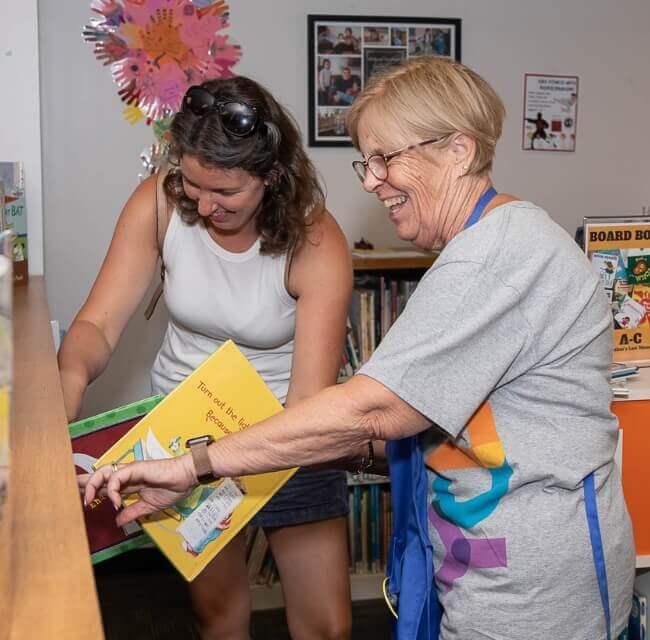 Employee Helping Customer At Dover Library