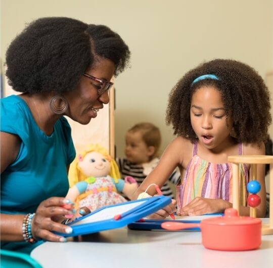 Woman And Girl Playing With Drawing Tablet At Red Land Library