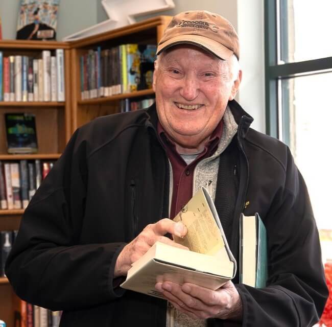 Older Man Smiling Holding Book